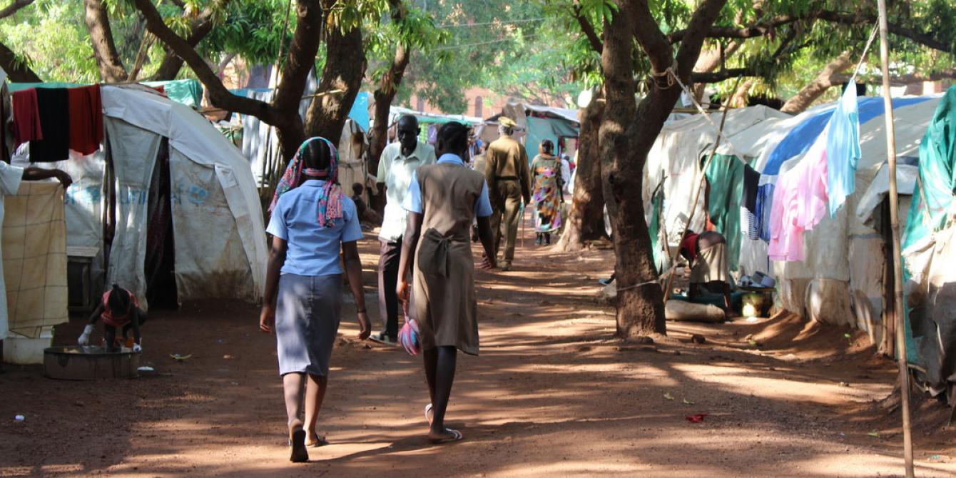 Residents walk through Cathedral camp in Wau, South Sudan. Tim Bierley/Oxfam