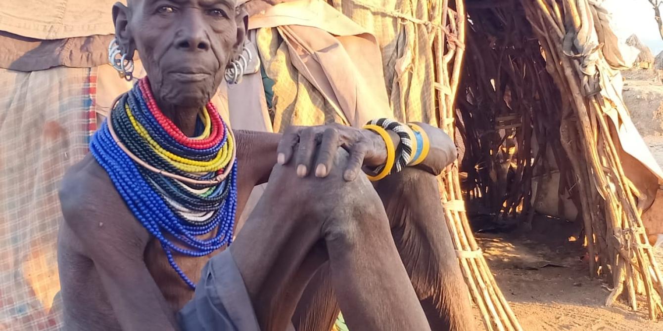 Eyapon seated outside her home.
