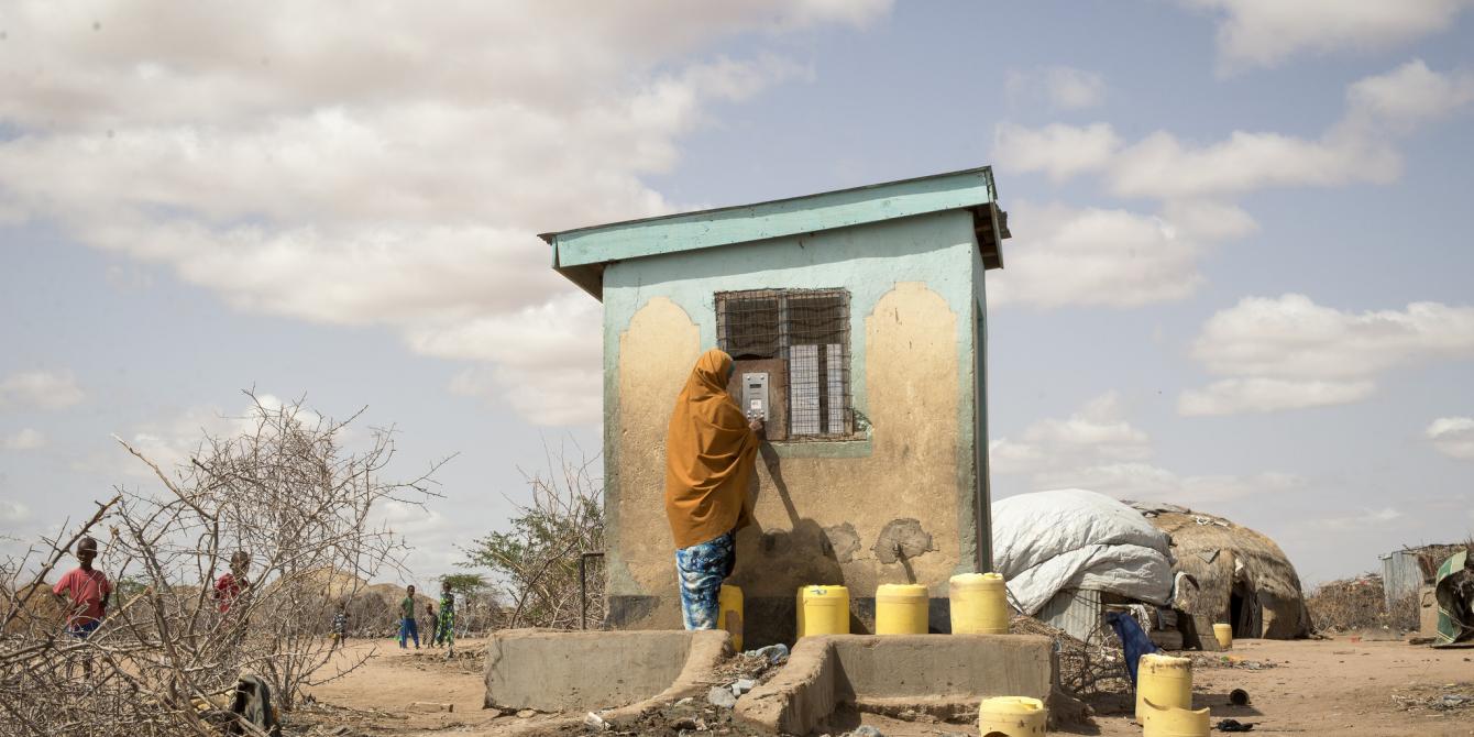 A woman uses her water credit, which is stored in a small, plastic token, to buy water from a Water ATM in Hadado, Kenya. Credit Katie G. Nelson/Oxfam A woman uses her water credit, which is stored in a small, plastic token, to buy water from a Water ATM in Hadado, Kenya. Credit Katie G. Nelson/Oxfam
