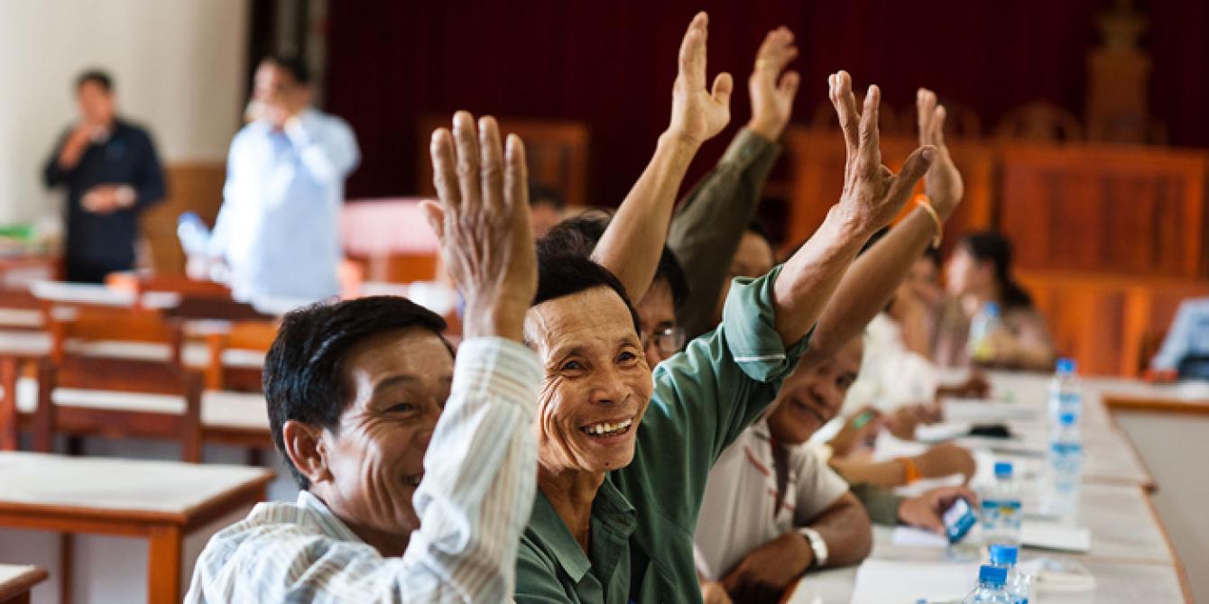 Oxfam vision and way to the future people raising their hands to claim their rights