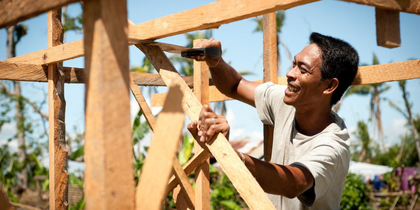 Larry Tondo,31, carpenter and chainsaw operator, builds a coconut lumber sales kiosk. (Photo: Eleanor Farmer) Larry Tondo,31, carpenter and chainsaw operator, builds a coconut lumber sales kiosk. (Photo: Eleanor Farmer)