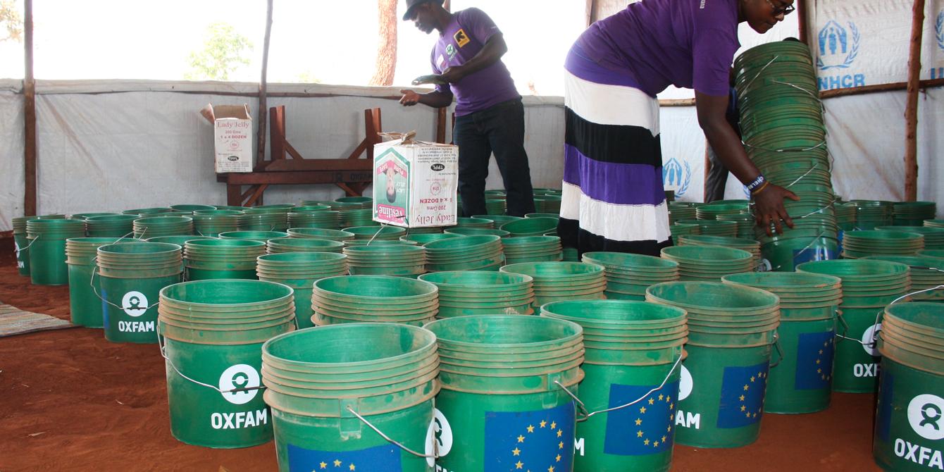 Public Health Promoters counting buckets before distributing it to the women refugees (Photo by Yussuf Kajenje) Public Health Promoters counting buckets before distributing it to the women refugees (Photo by Yussuf Kajenje)
