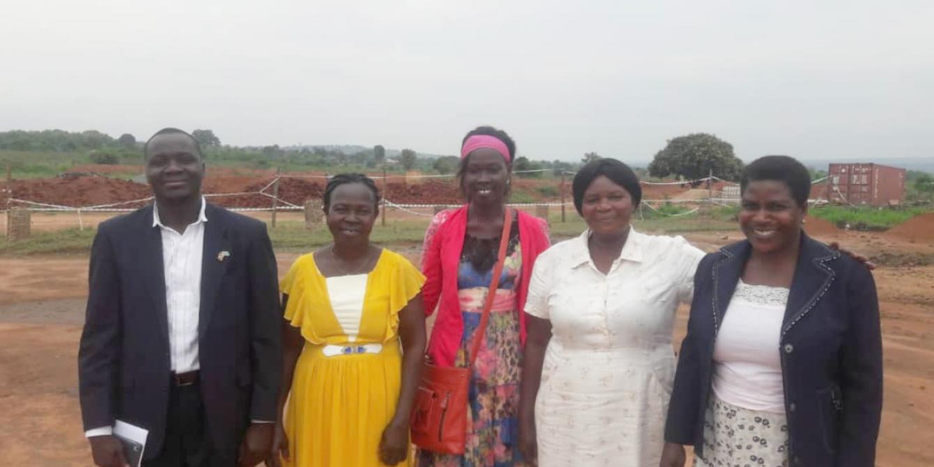 Omito Robert Steen LC5 Chairman Packwach District with some of the women he works with to champion women's rights. Photo: Charity Chelangat/Oxfam